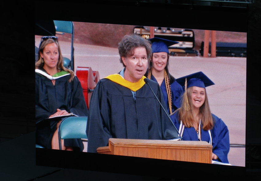 EHS English teacher Colin Booth can be seen on a large screen as he spoke to graduates and the crowd. The class of 2021 selected him to speak at commencement.